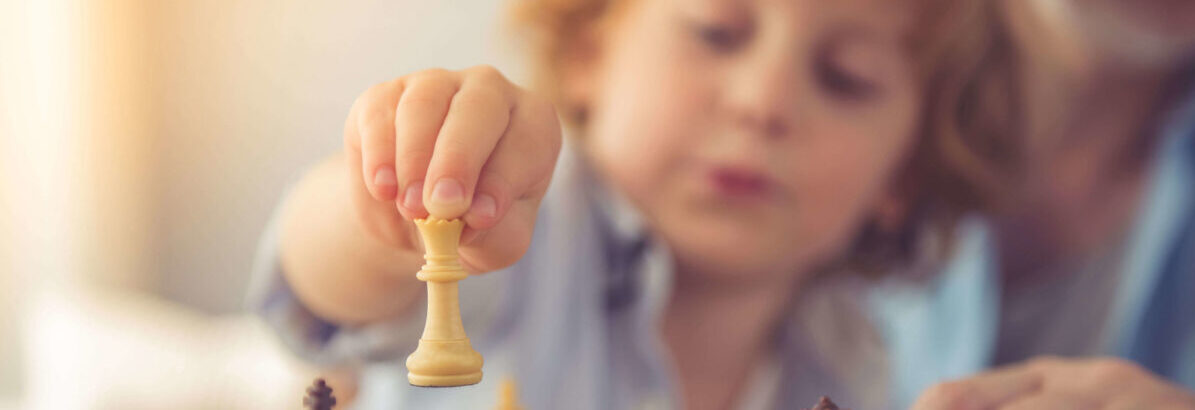 A child playing chess symbolising planning and strategy