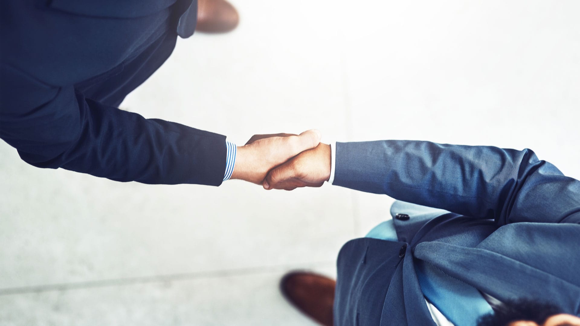 Mkc Wealth Men Handshake Arial View Pension Enforcment